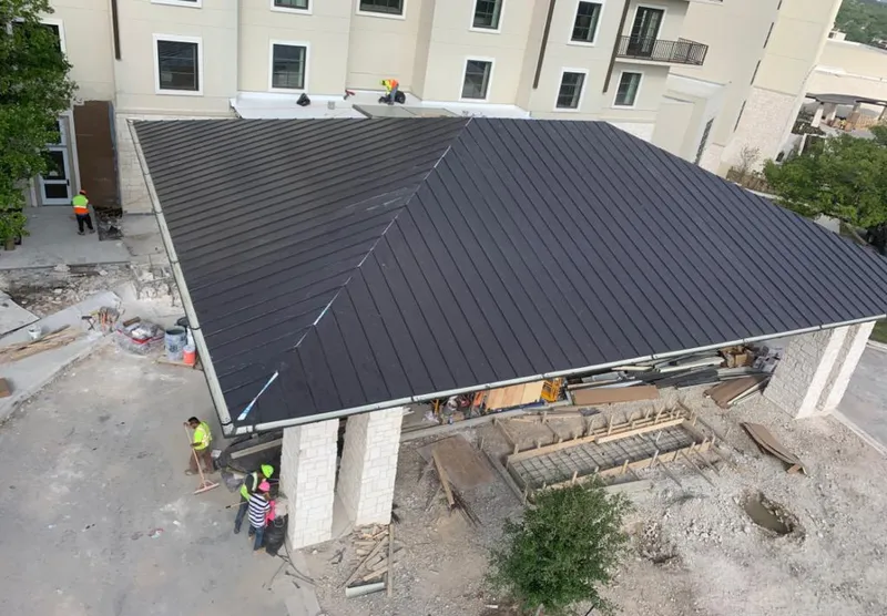 Metal roofing installation team working on a commercial building in Des Plaines
